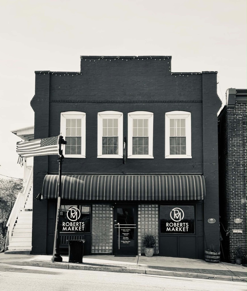 Roberts Market today — black-and-white photo of the brick storefront with striped awning at 216 Virginia Avenue